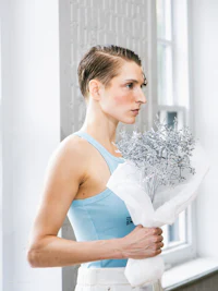 a woman holding a bouquet of flowers