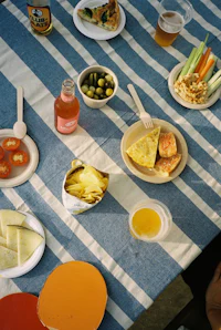 a table full of food on a blue and white striped tablecloth