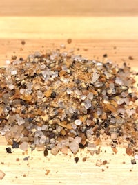 a pile of salt on a wooden table