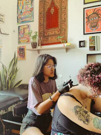 a woman getting a tattoo