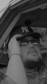 a black and white photo of a man in a car