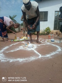 a man drawing a circle on the ground