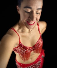 a woman in a red belly dance outfit posing for a photo