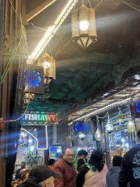 a group of people standing in a restaurant