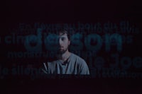 an image of a man in a dark room