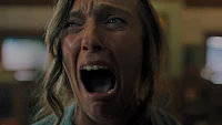 a woman is screaming in a room