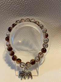 a bracelet with a silver elephant on it