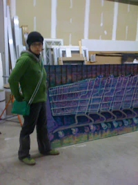a person standing in front of a large painting