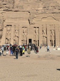 a group of people standing in front of a large building