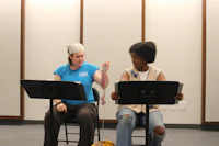 two women sitting on chairs in a room