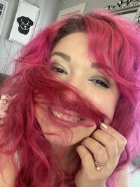a woman with pink hair posing for a photo
