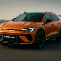 a new orange suv is driving down a road