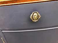 a drawer with a brass knob on it