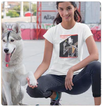 a woman kneeling down next to a dog wearing a white t - shirt