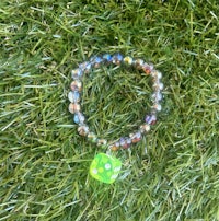 a bracelet with a green and yellow dice on it