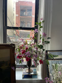 a vase of flowers on a window sill