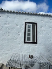 a white house with a window and a table
