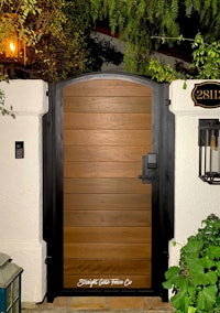 a wooden gate with a sign in front of it