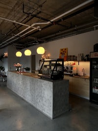 the inside of a coffee shop with tables and chairs