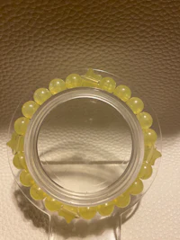 a yellow bead ring on a mirror