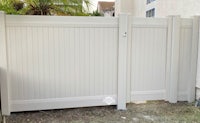 a white fence in front of a house