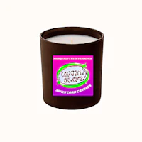a candle with a pink label on it