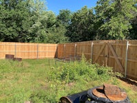 a backyard with a wooden fence