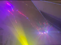 a room with green and blue lights in the background