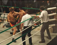 two men are fighting in a boxing ring