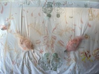 a room with a pink wall covered in paper