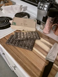a knife on a cutting board next to a box of chocolate bars