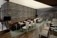 a restaurant with a brick wall and wooden tables