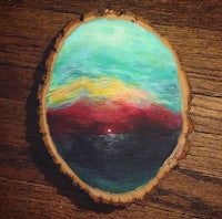 a piece of wood with a painting on it