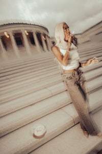 a woman is standing on steps in front of a building