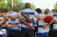 a group of rugby players in a huddle