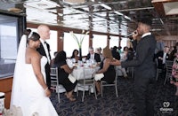 a bride and groom giving a toast on a boat