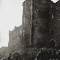 an old black and white photo of a castle