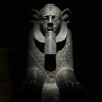 a statue of an egyptian sphinx in the dark