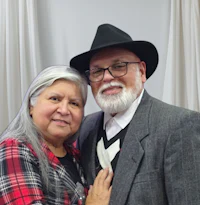 an older man and woman posing for a photo