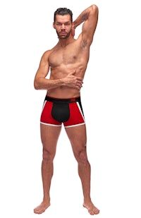 a man in a red and black boxer short posing