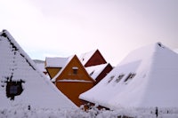 a row of houses covered in snow
