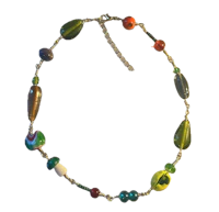 a necklace with colorful glass beads on a black background