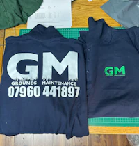 two gm t - shirts on a cutting board