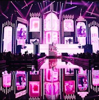 a stage with pink lights and a stage in front of it