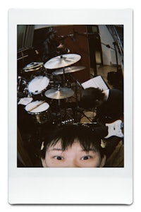 a photo of a person in front of a drum set