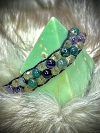 an amethyst bracelet with purple and green beads