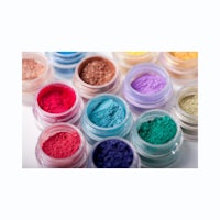 a variety of colored powders in jars on a white background