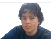 an image of a young man with curly hair