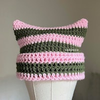 a pink and green striped hat on a mannequin