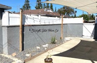 a backyard with a fence and a sign